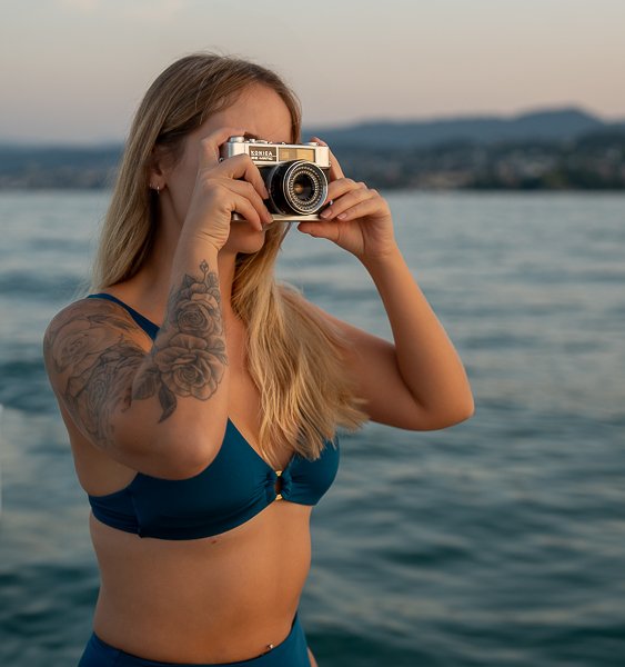 Promoting Healthy body image by showing a women in sustainable swimwear with a camera.